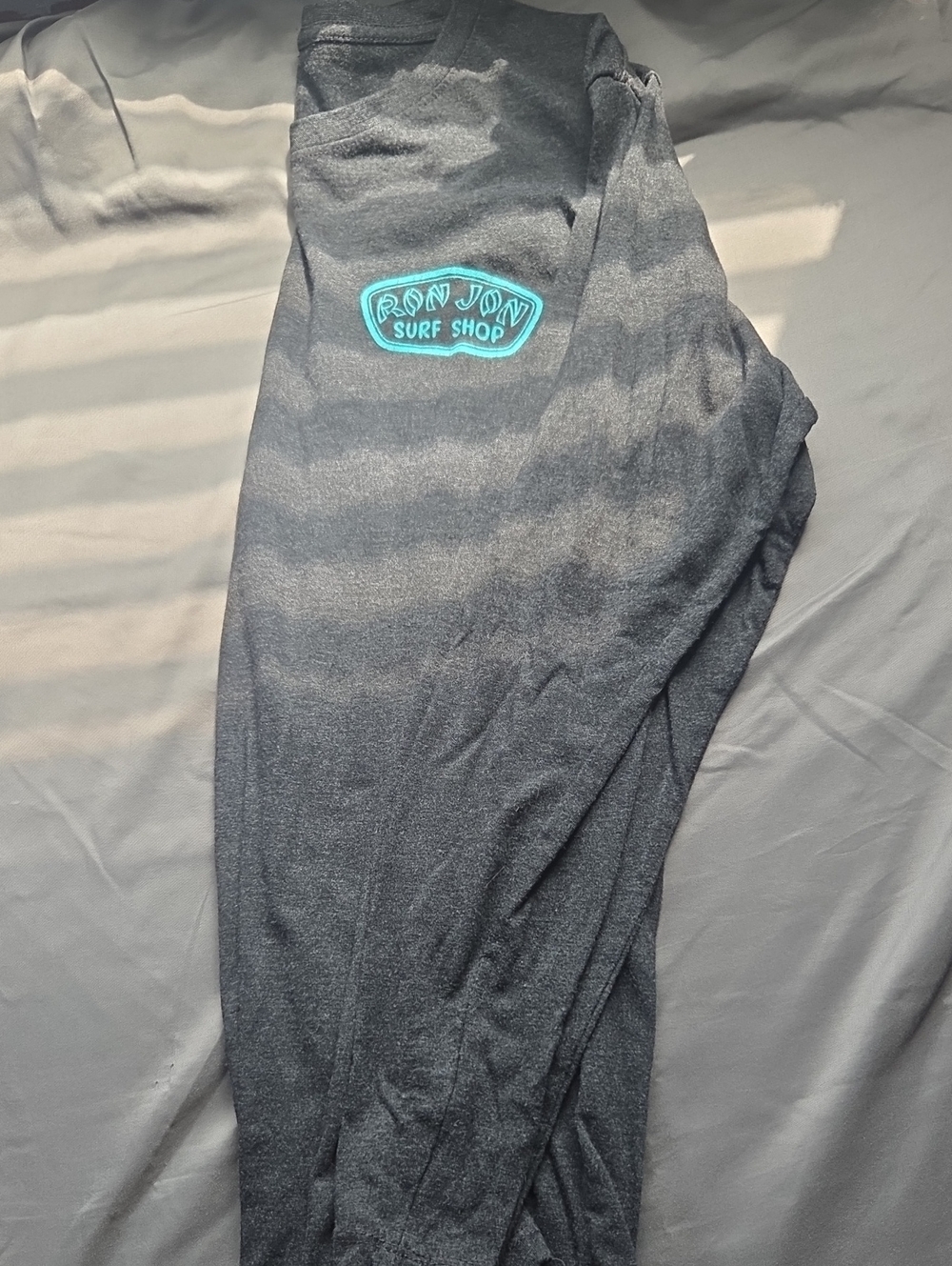 Ron Jon Black Shirt with Teal Logo